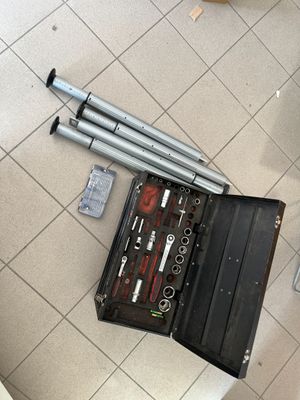 a tool kit sitting on the floor next to a toilet