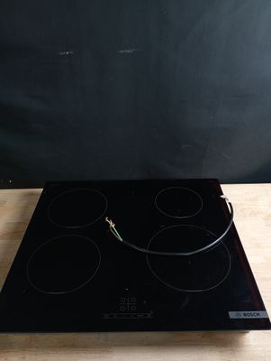 an electric stove top with three burners on a wooden table