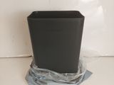 a black trash can sitting on top of a plastic bag
