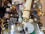 a box full of bottles of perfume and other items