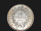 a close up of a silver coin with a wreath on it