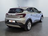 the rear end of a silver car in a white room