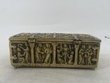 an antique brass box with a group of people on it