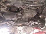 the underside of a car with a broken engine and a broken exhaust pipe