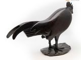 sculpture of a rooster on a rock on a white background