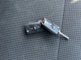 two car keys laying on top of each other on a car seat