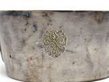 a silver bowl with a gold design on it