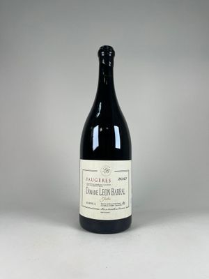 a bottle of wine sitting on top of a white table