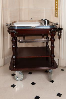 a small wooden table with a metal tray on it