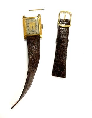 pair of brown leather watch straps with gold buckles on a white surface