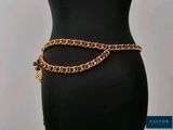 a mannequin with a gold chain belt on a mannequin