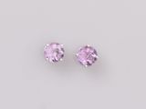une paire de boucles d'oreilles en saphir rose sur fond blanc