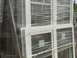 a large stack of windows sitting on a pallet