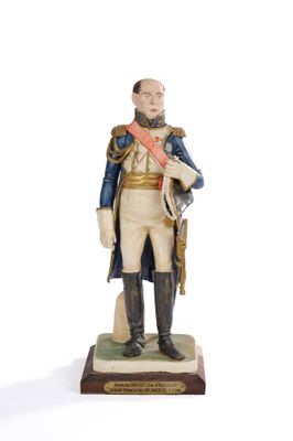 figurine of a man in a military uniform holding a sword