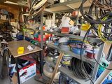 a garage with a lot of tools and a lot of clutter