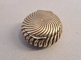 an image of a silver button with a spiral design
