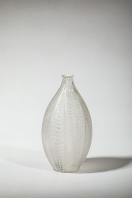 a glass vase that is sitting on a white surface
