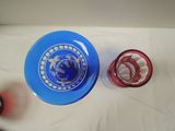 a blue frisbee and a red glass on a white table