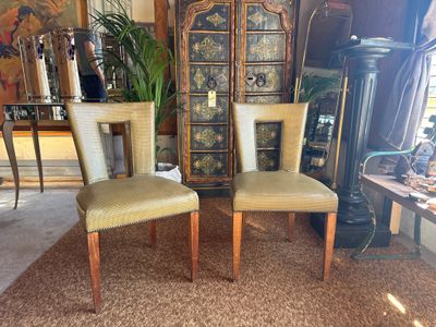 two chairs that are sitting next to each other in a room