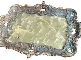 a picture of a silver plate with a mirror in it
