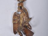 a bird on a keychain hanging on a wall