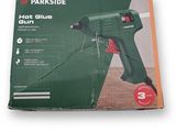 a close up of a box with a hot glue gun in it