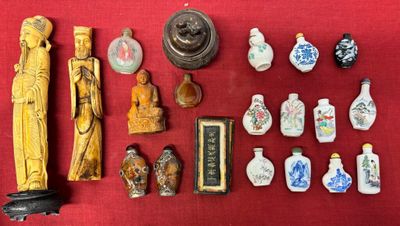 a lot of asian figurines on a red cloth