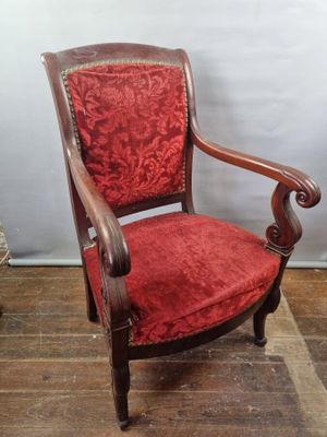 an image of a red chair sitting on top of a wooden floor