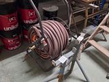 a fire hose on a stand in a garage