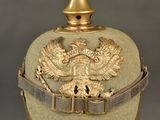 an old military helmet with a gold eagle on it