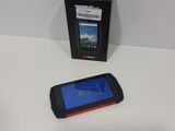 a cell phone sitting next to a box on a table