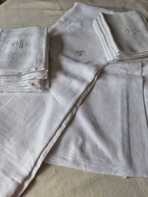 a pile of towels on a bed next to a pair of scissors