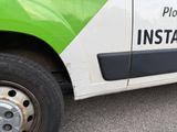 a green and white truck with a black and white sign on the side