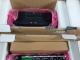 two boxes of electronic equipment sitting on top of a white surface