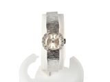 an image of a woman ' s wrist watch on a display stand