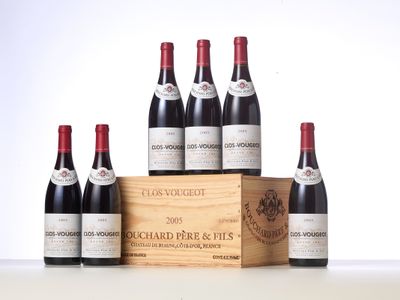 six bottles of red wine in a wooden box on a table