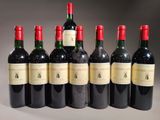 six bottles of red wine lined up in a row on a table