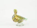 a glass bird that is standing on a glass base