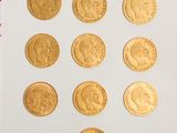 a lot of gold coins sitting on a white surface