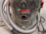 a vacuum that is sitting on the floor in the garage