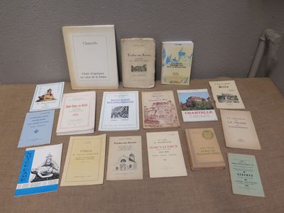 a lot of books on a table that are sitting on the table