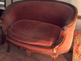a couch and a chair in a room with a mirror