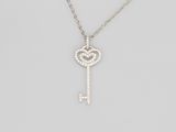 a diamond key pendant on a chain