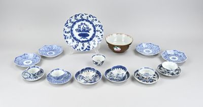 an assortment of blue and white plates and bowls on a table