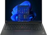 the laptop is open on a white surface with a blue background
