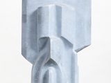 sculpture of a face on a pedestal on a white surface
