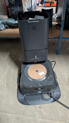 a cd player sitting on the floor next to a computer