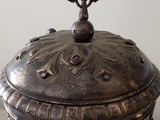 a silver box with a cross on top of it