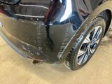 a car that has been painted black in a garage