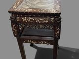 an old wooden table with a marble top and a drawer underneath it